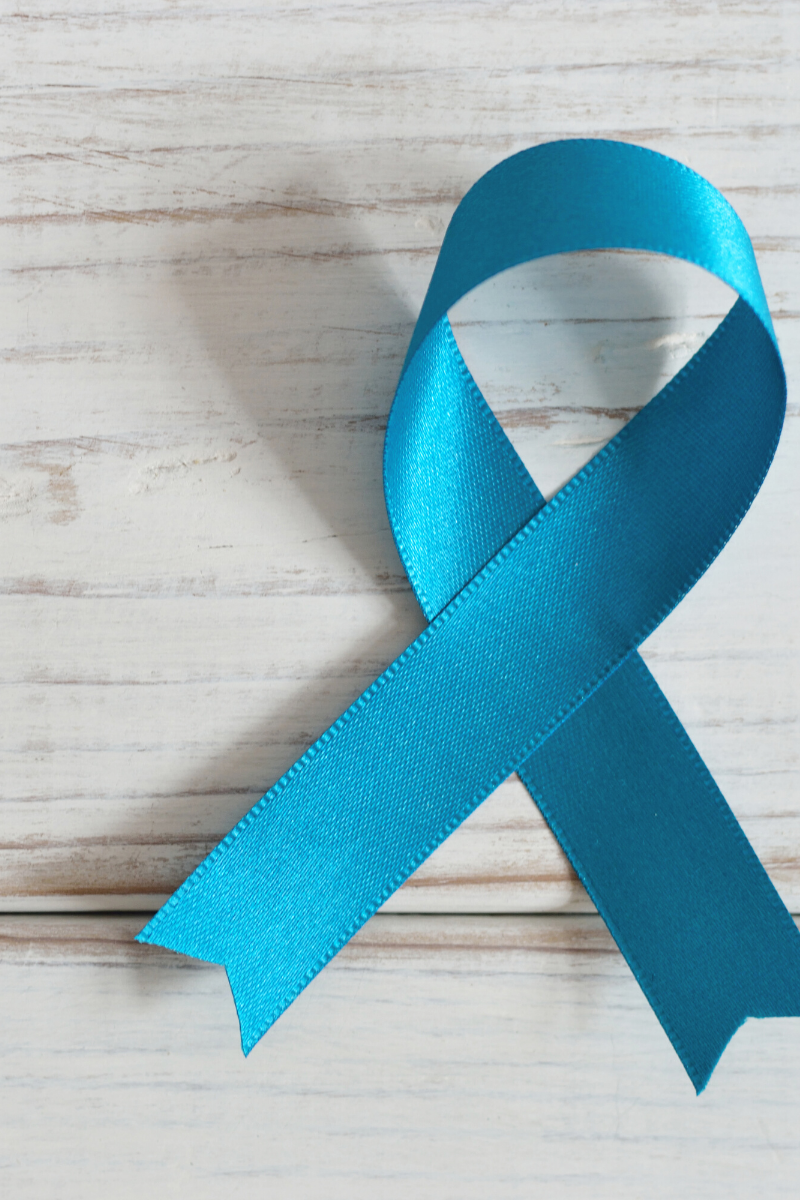 a blue ribbon on a wooden surface.